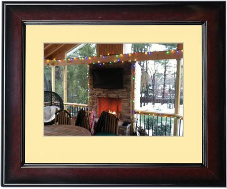 Cozy porch with a lit fireplace and outdoor seating.