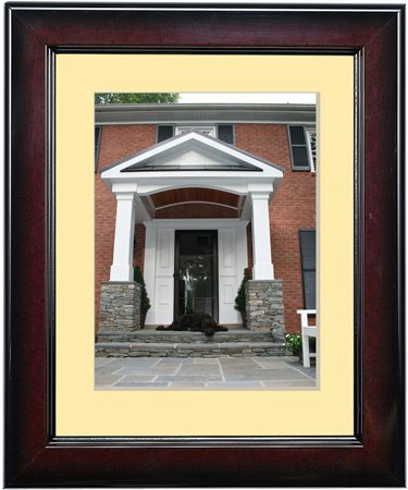 A framed photo of a building entrance with white pillars and a triangular pediment.