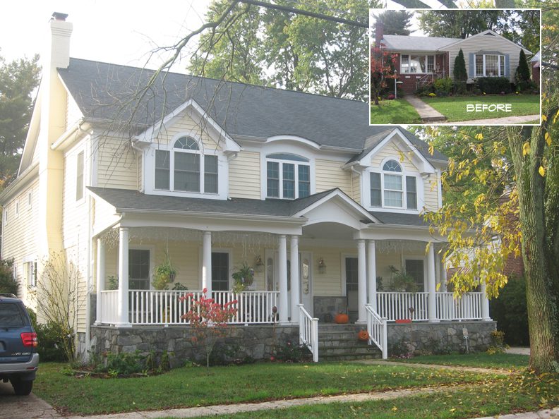 A charming two-story house with a porch and a stone foundation.