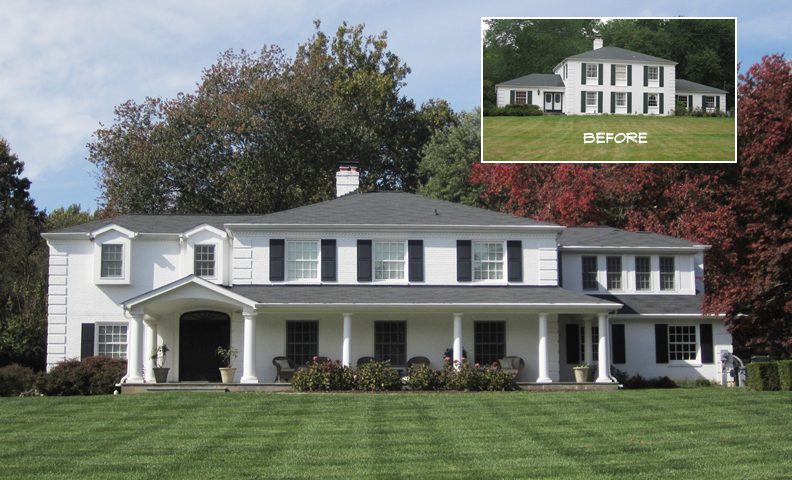 Large white colonial-style house with expansive front porch and green lawn.