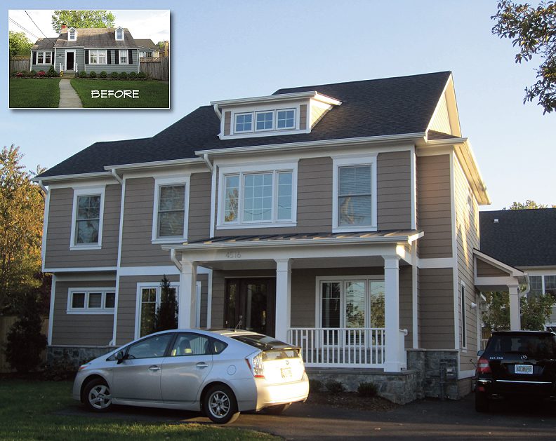 Large gray two-story house with dormer windows and a silver car parked outside.