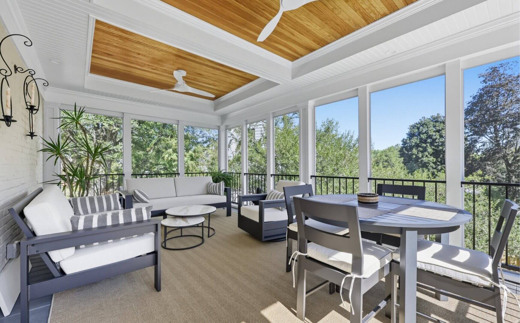 Sunroom with gray furniture and dining table