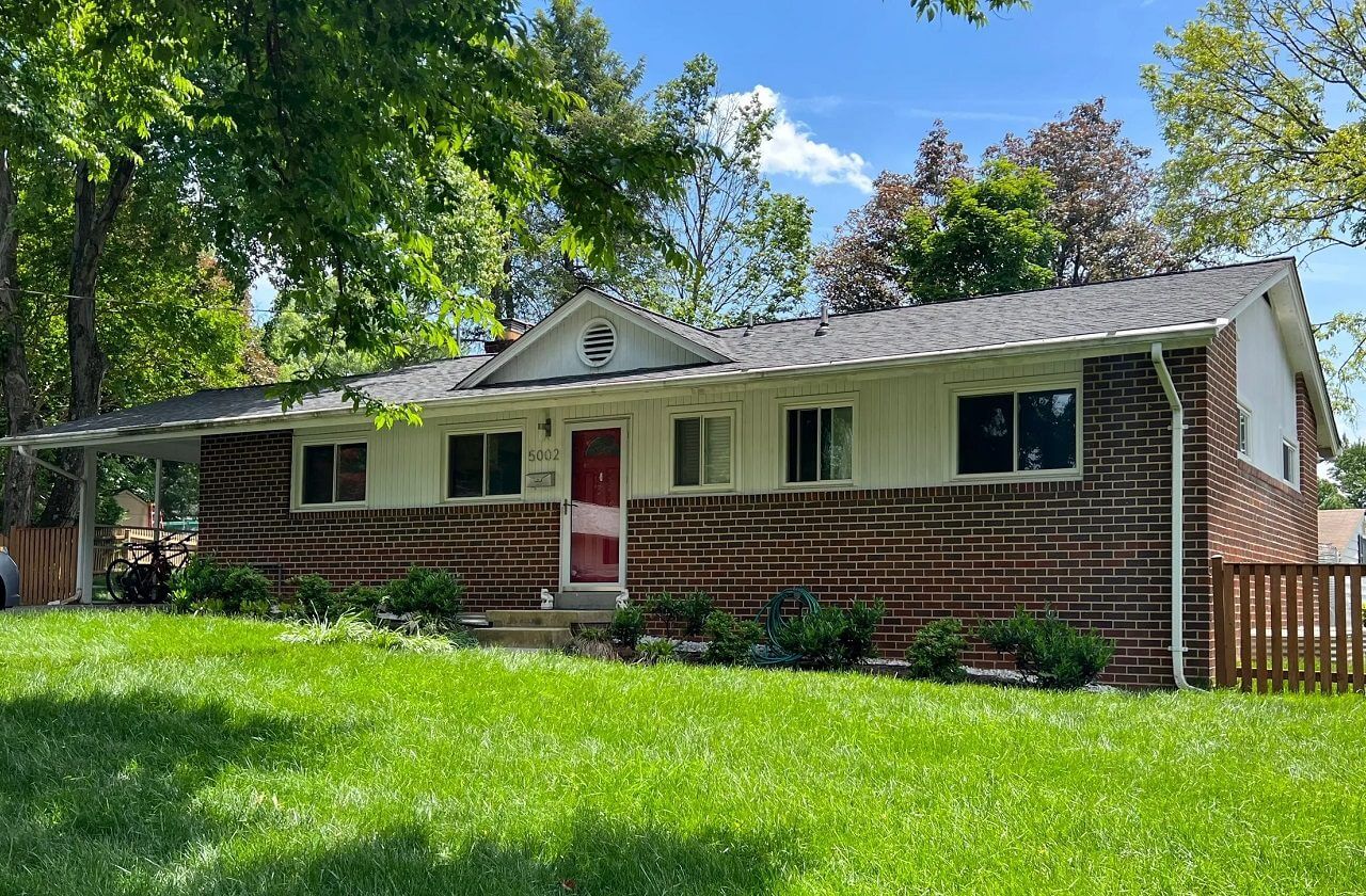 Single-story brick house with red door
