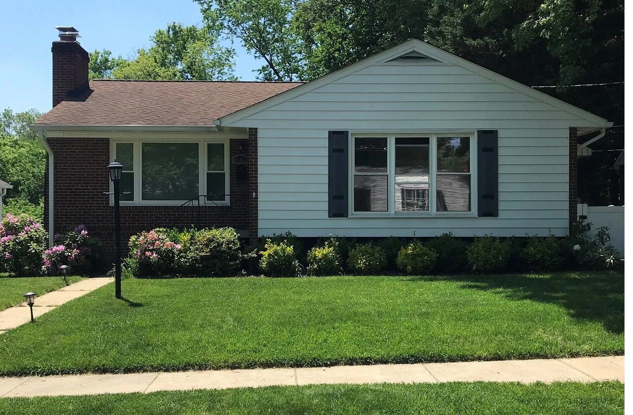 Single-story suburban house with manicured lawn